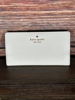 kate spade off white saffiano leather bi fold wallet with taupe inside!